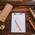 yellow pencil on white paper and carpentry tools